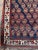 This antique Sheeraz tribal rug features a captivating field of repeating gul motifs, each framed within octagonal...