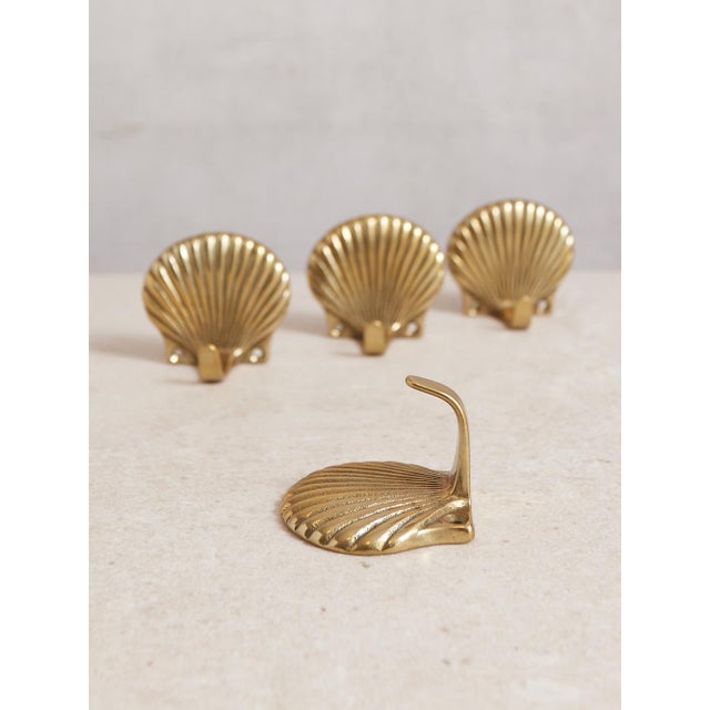 Set of 4 lacquered brass shell hooks. A great size for a bathroom, mudroom, or entryway. These would be great attached...