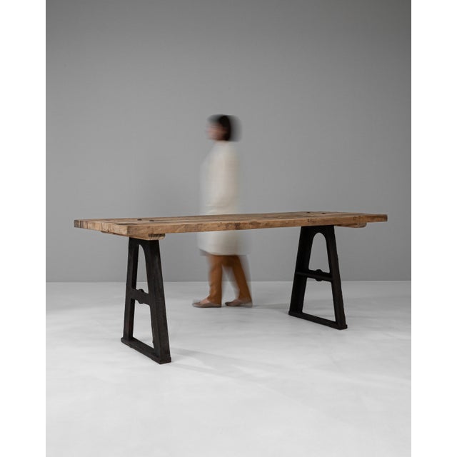 This Early 20th Century French Industrial Table is a splendid representation of utilitarian design fused with rustic...