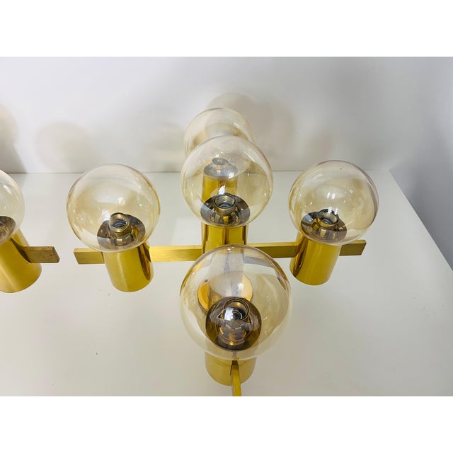 This exquisite brass and glass chandelier, designed by the renowned Swedish designer Hans-Agne Jakobsson in the 1960s, is...