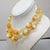 1960s 2-strand goldtone with orange spherical textured beads with yellow facetd bead spacers necklace with hook clasp and...