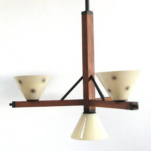 This art Deco lamp features a wooden structure with four glass shades and was manufactured in the 1930s. European Plug (up...