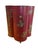 This is a large red tole wastebin in a quatrefoil shape. It is painted with chains and foliage and has two ring handles...