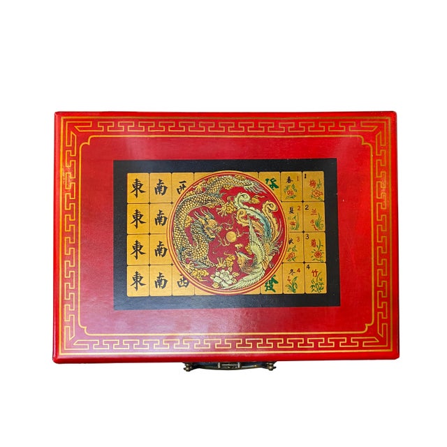 This is a traditional Chinese tile game set - Mahjong. The box surface is a red color vinyl with an oriental scenery...