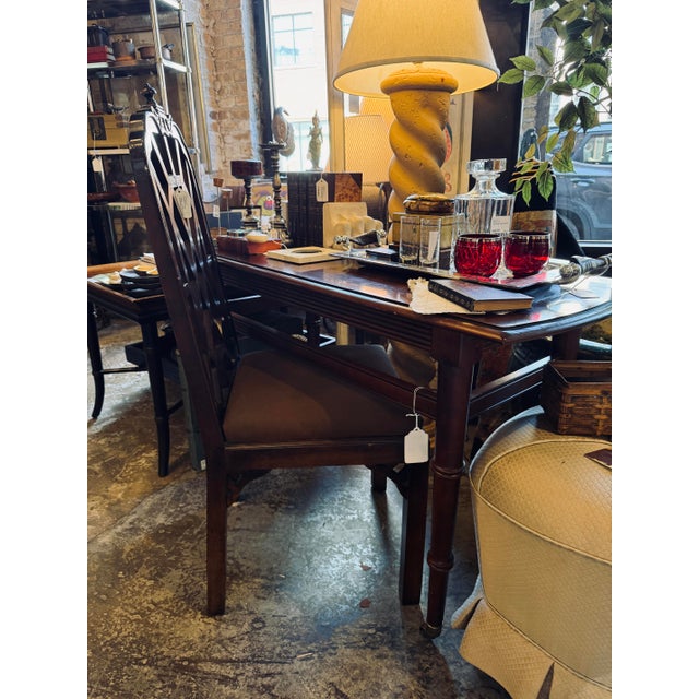A beautifully crafted vintage console table by Ethan Allen, featuring elegant faux bamboo–style legs that bring a subtle...