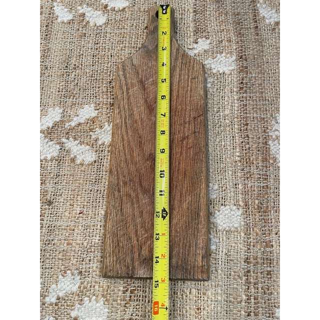 This vintage rustic wooden bread board features a weathered grain finish, adding character and charm to any kitchen or...