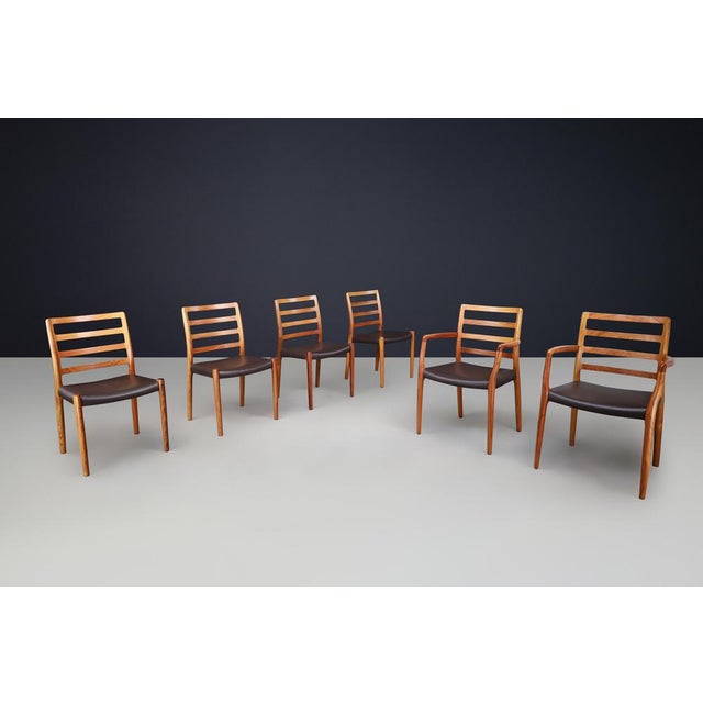 This is a stunning set of six dining room chairs, model 85, designed by Niels Otto Møller and manufactured by J.L. Møllers...