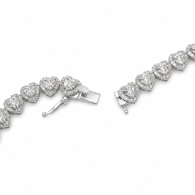 A romantic take on a diamond line necklace, this 10K White Gold design is formed from repeating heart-shaped links set...