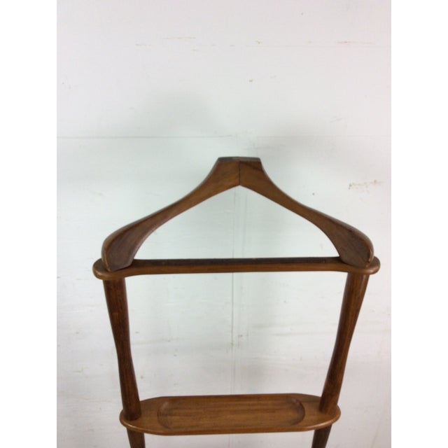 This mid century modern gentleman’s valet features hardwood construction, original walnut finish, sculpted hanger like...