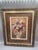 Elegant floral still-life reproduction featuring a lush arrangement of irises, lilies and other garden flowers displayed...
