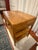 A handsome Theodore Alexander nightstand or side table featuring geometric oak parquetry, warm wood tones, and a...