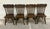 This is a gorgeous complete set of four vintage, possibly antique, oak lion head press back traditional dining chairs....