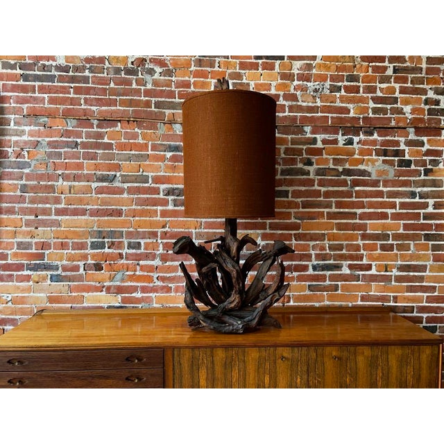 Illuminate your space with the raw beauty of nature captured in this unique sculptural driftwood table lamp. This...