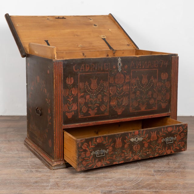 19th century Hungarian flat top trunk crafted in pine with original hand painted decoration. The surface features a dark...