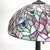 A table lamp crafted in the distinctive Arts & Crafts style, featuring a dome-shaped leaded stained glass shade showcasing...