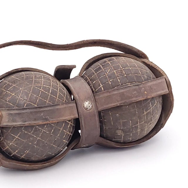 A pair of bocce balls with leather carrier, circa 1900. Measurements are of the balls together in the carrier.