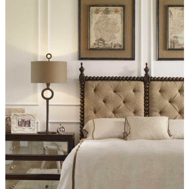 Hammered cast iron finished in an aged rust bronze. The round hardback drum shade is a rust beige linen fabric....