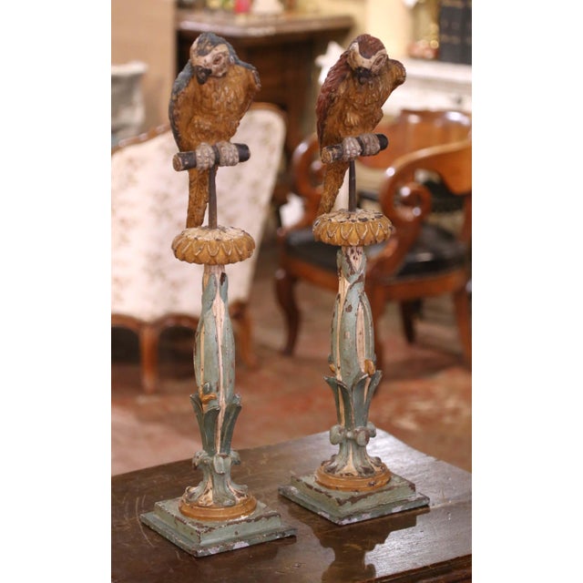 Whimsical and full of character, this rare pair of Italian carved wood candlestick stands was crafted circa 1850 and...
