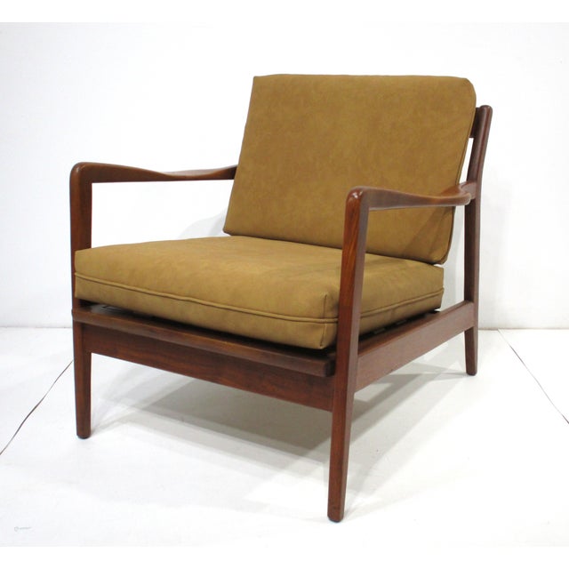 Exceptional dark walnut Danish lounge chair with wonderful, sculptural curved arm rests and two cushions upholstered in a...