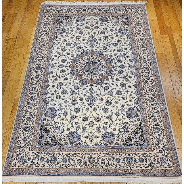 "This extremely fine hand knotted Persian Nain rug, crafted in the 4th quarter of the 1900s. Set on a soft ivory...