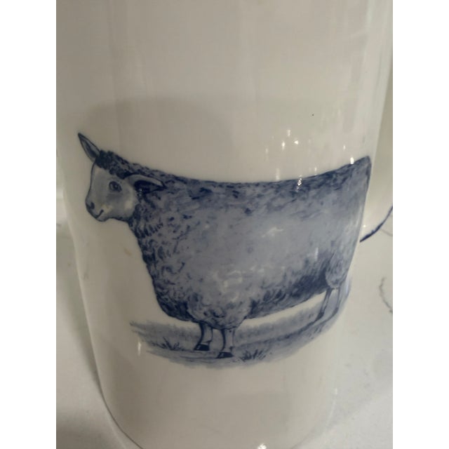 Vintage White Jug / Pitcher With a Sheep on Both Sides With Blue Trim From England This jug / pitcher was made in...