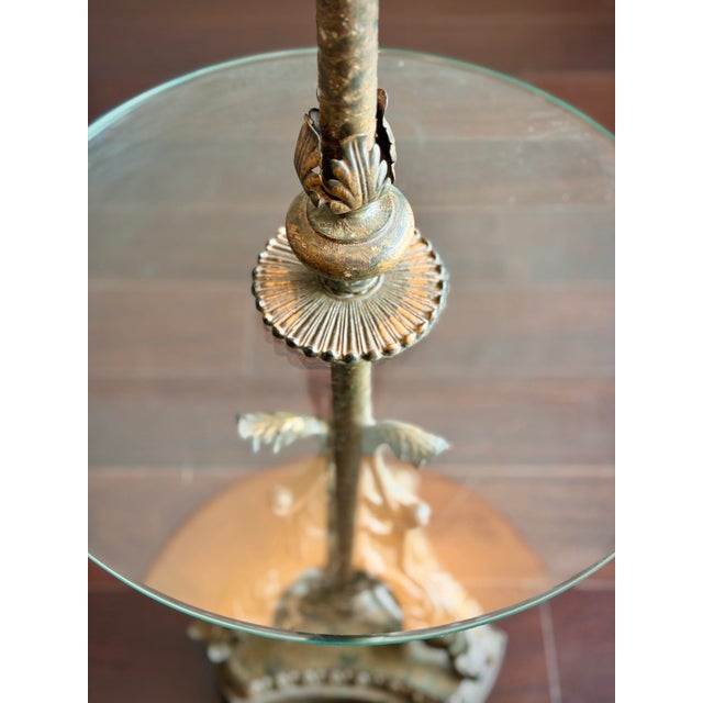 A dramatic vintage Hollywood Regency floor lamp with an integrated round glass table, dating approximately to the late...
