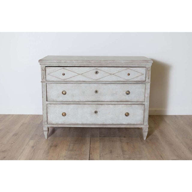 A beautiful 19th-century Swedish Gustavian-style commode, circa 1860, painted in a soft gray with a delicate hint of...
