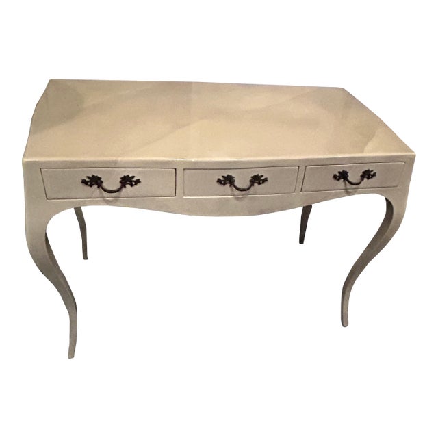 Elegant cream colored lacquered parchment writing desk that looks like goat skin, with bronze handles and cabriole legs....