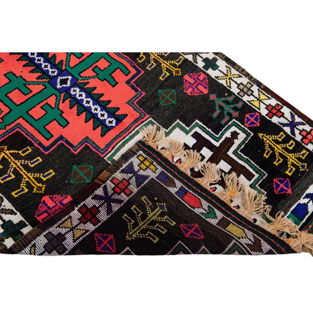 Beautiful vintage Turkish hand-knotted wool rug with a brown field. This rug has a white designed frame and multicolor...