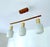 Mid Century Danish modern pendant light featuring a teak wood suspension and 3 opaline glass shades Dimensions: Height 58...