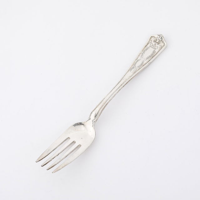 This refined sterling silver dessert fork by Tiffany & Co. features the distinguished Winthrop Pattern, a timeless design...