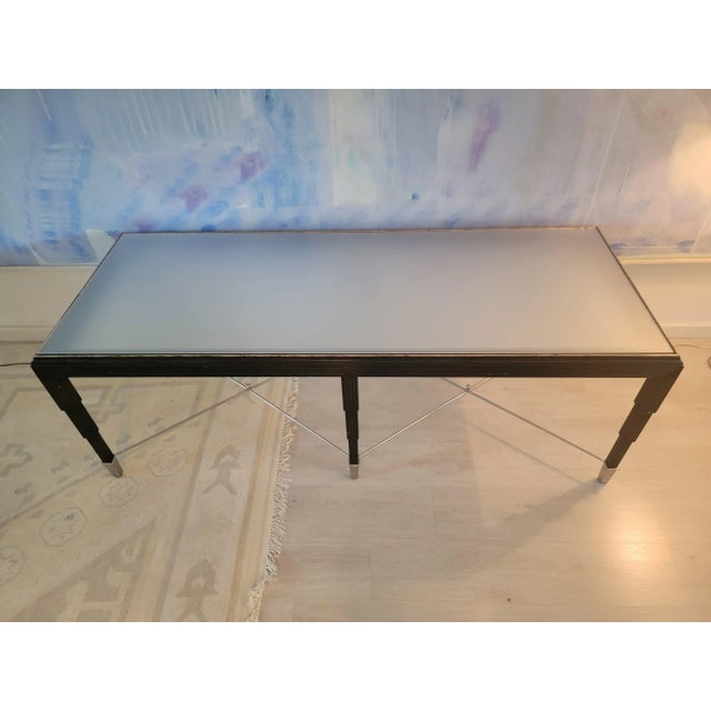 Large scale art-deco style influeced coffee table. Wood table with walnut finish. Nickel plated double stretcher and...