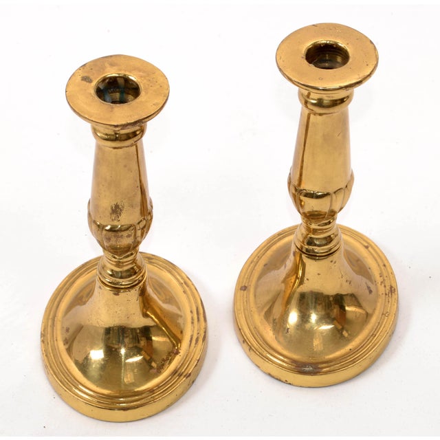 Pair of 1950s Traditional heavy Brass Candle Holders with oval saucer base. In good vintage condition with gold aged...