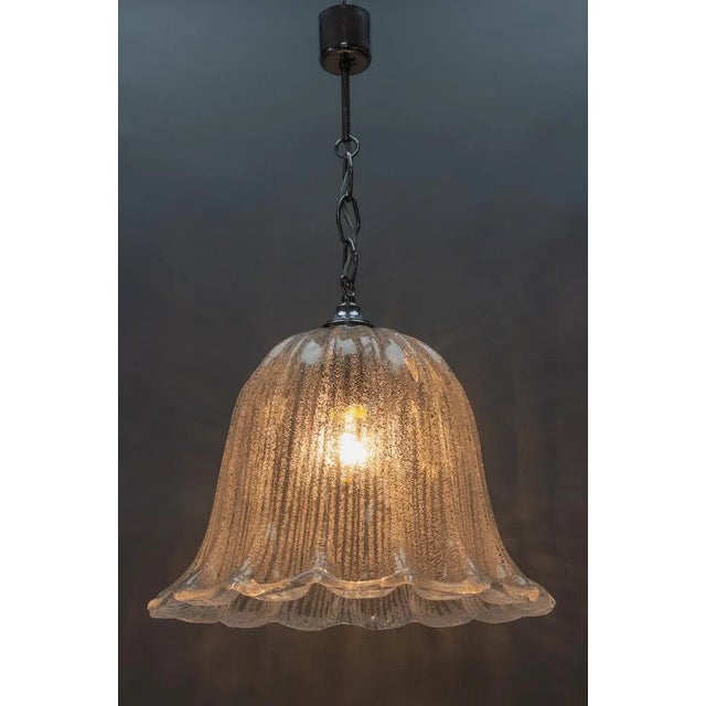 - Mid-Century Modern pendant light fixture with beautifully shaped ice glass shade and chrome-plated metal fitting. - One...