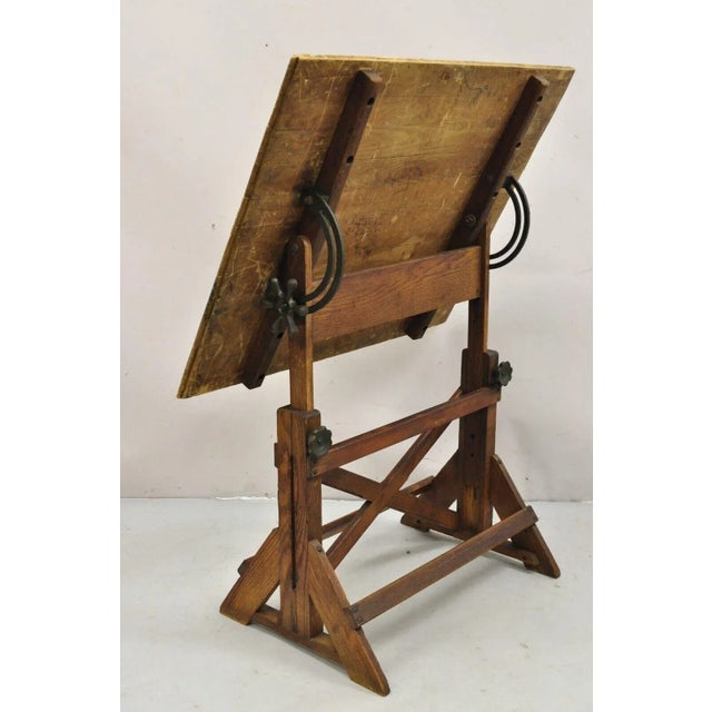 Vintage F. Weber Co. Oak, Pine, and Cast Iron Adjustable Drafting Table. Item features a desirable top with paint and...