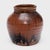 This antique Chinese jar from the early 20th century is cloaked inside and out with a beautiful drip glaze of red-brown...