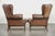 This charming set of 2 English-style cowhide wing armchairs is finished with decorative nails. These charming wing...