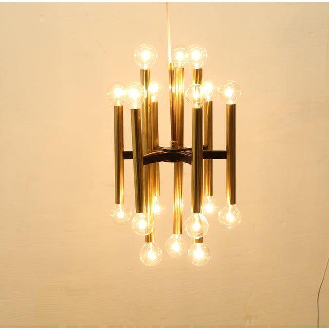 Brass chandelier from the mid-century, 18 lights. by Gaetano Sciolari featuring an assemblage of multiple brass tubes...