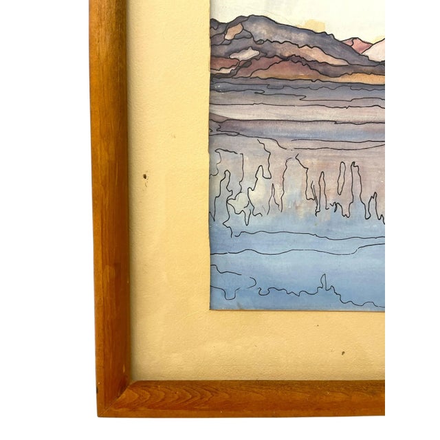 This framed landscape artwork, signed Mary ‘69 in the lower right corner, appears to be a watercolor on paper. The...