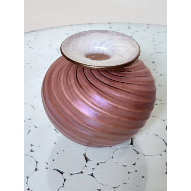 Very pretty small vase signed by artist. It has a very nice earthly color that would blend in well any other colors in the...