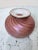 Very pretty small vase signed by artist. It has a very nice earthly color that would blend in well any other colors in the...
