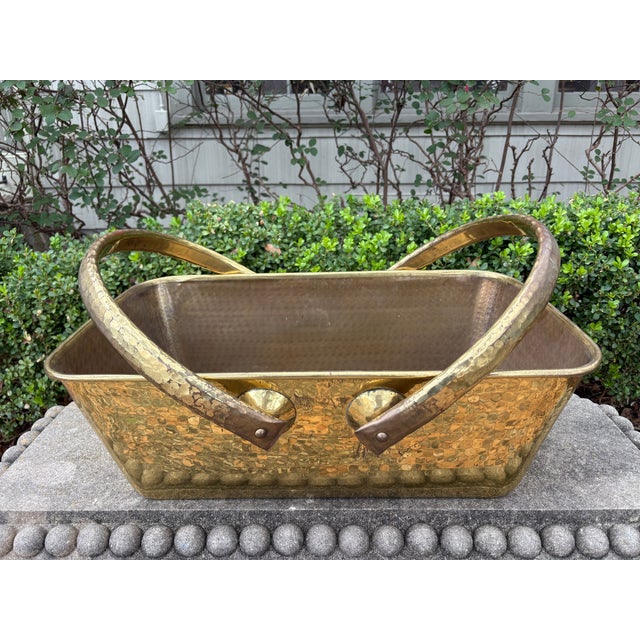 Hollywood Regency Brass Basket. Offered is a beautiful large mid-century rectangular hammered brass basket with handles....