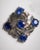 A very unusual pair of stud earrings comprised of abalone shell, round faceted kyanite gemstones and rays of round faceted...