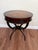 Mid-20th century Regency Revival drum table crafted in mahogany with a tooled leather inset top and classic lion-head ring...