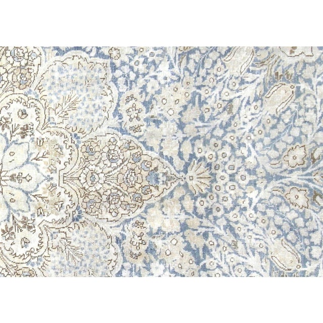 This semi-antique Persian Tabriz rug measures 8'7" x 12'2" and was hand-woven in Northern Iran using traditional...