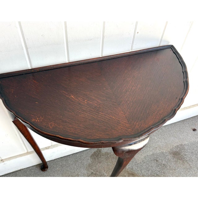 Early-20th century Queen Anne style mahogany demilune table. Some extremely minor signs of surface wear on top, as shown....