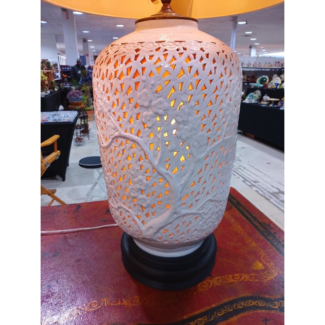 These lamps are HUGE! Gorgeous pair of white glazed table lamps with reticulated pattern and floral motifs, raised on...