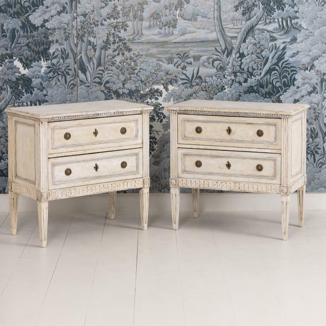 A charming pair of Italian bedside commodes from the late 19th century painted a soft cream with a subtle gray outlining...