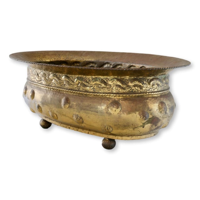 Baroque-style Italian brass planter, circa 1960s, featuring bold repoussé scrollwork, domed rivet detailing, and a fully...