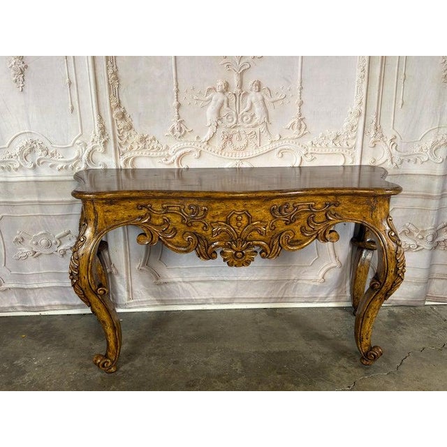 An exquisite Italian Rococo Revival console table, a true statement of Old World craftsmanship and timeless grandeur. This...